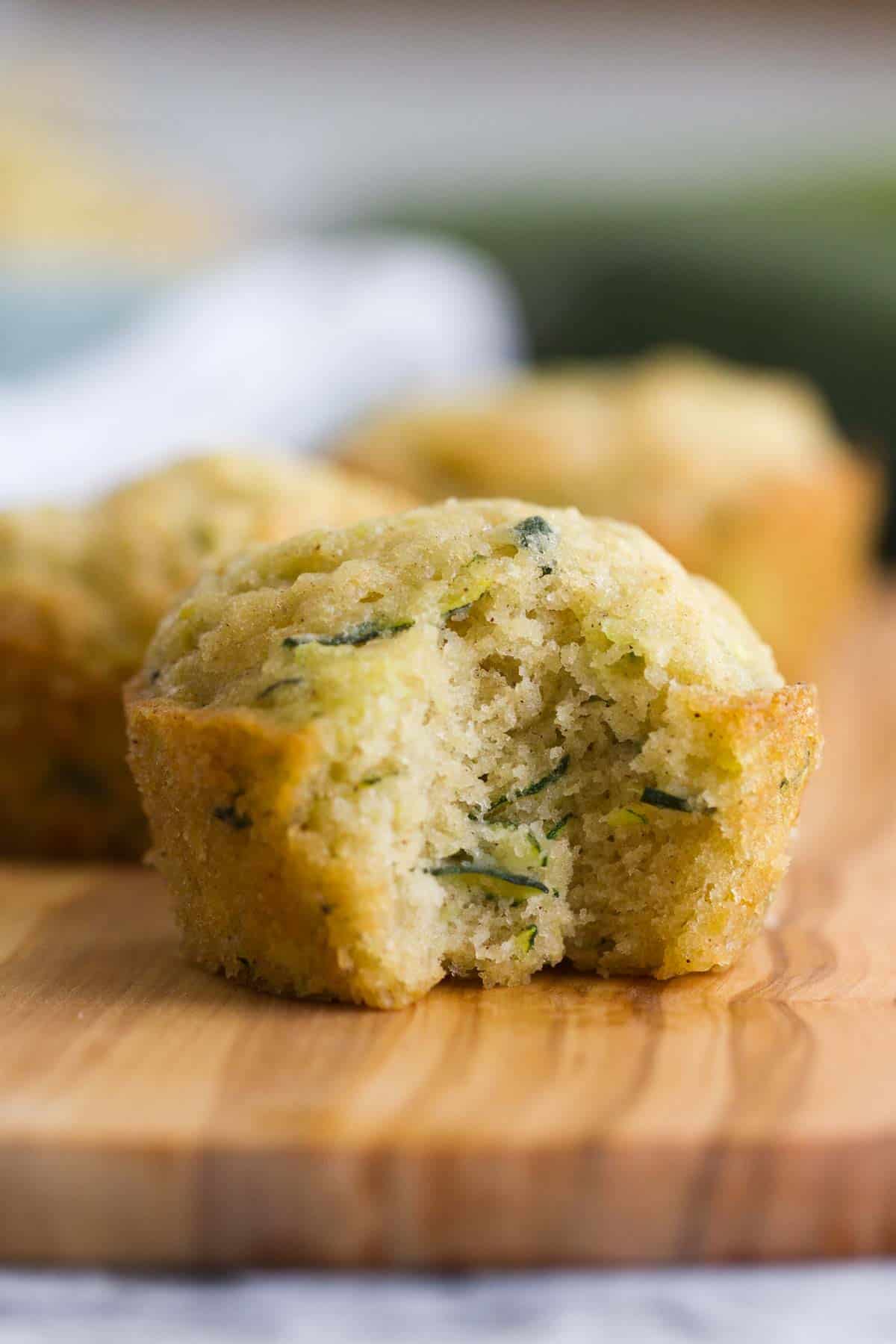close up of zucchini muffin with a bite taken from it