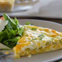 Slice of green chile tortilla pie on a plate.