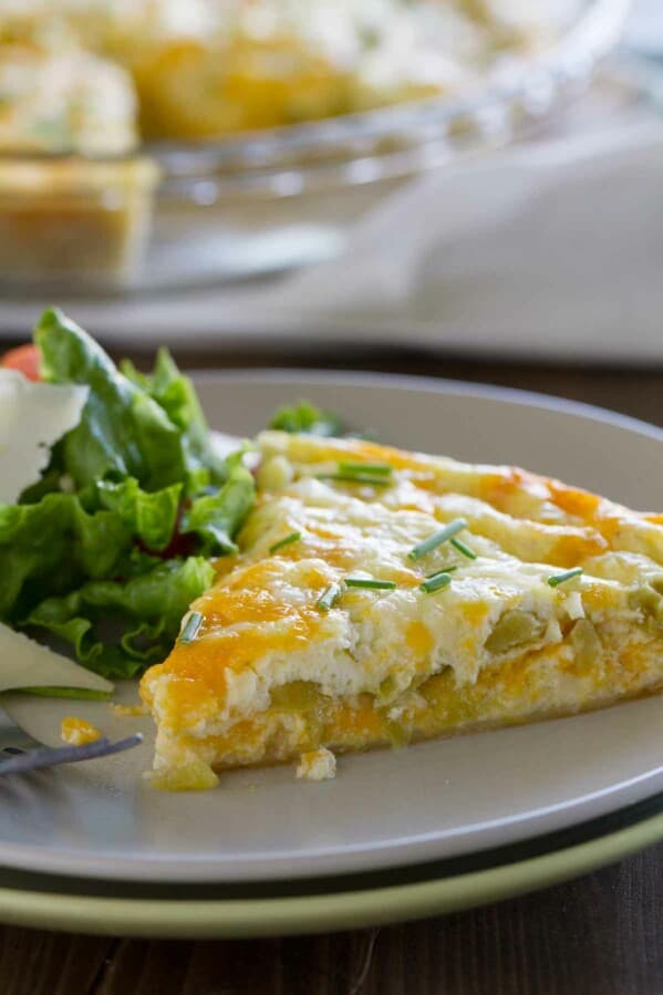 Slice of green chile tortilla pie on a plate.