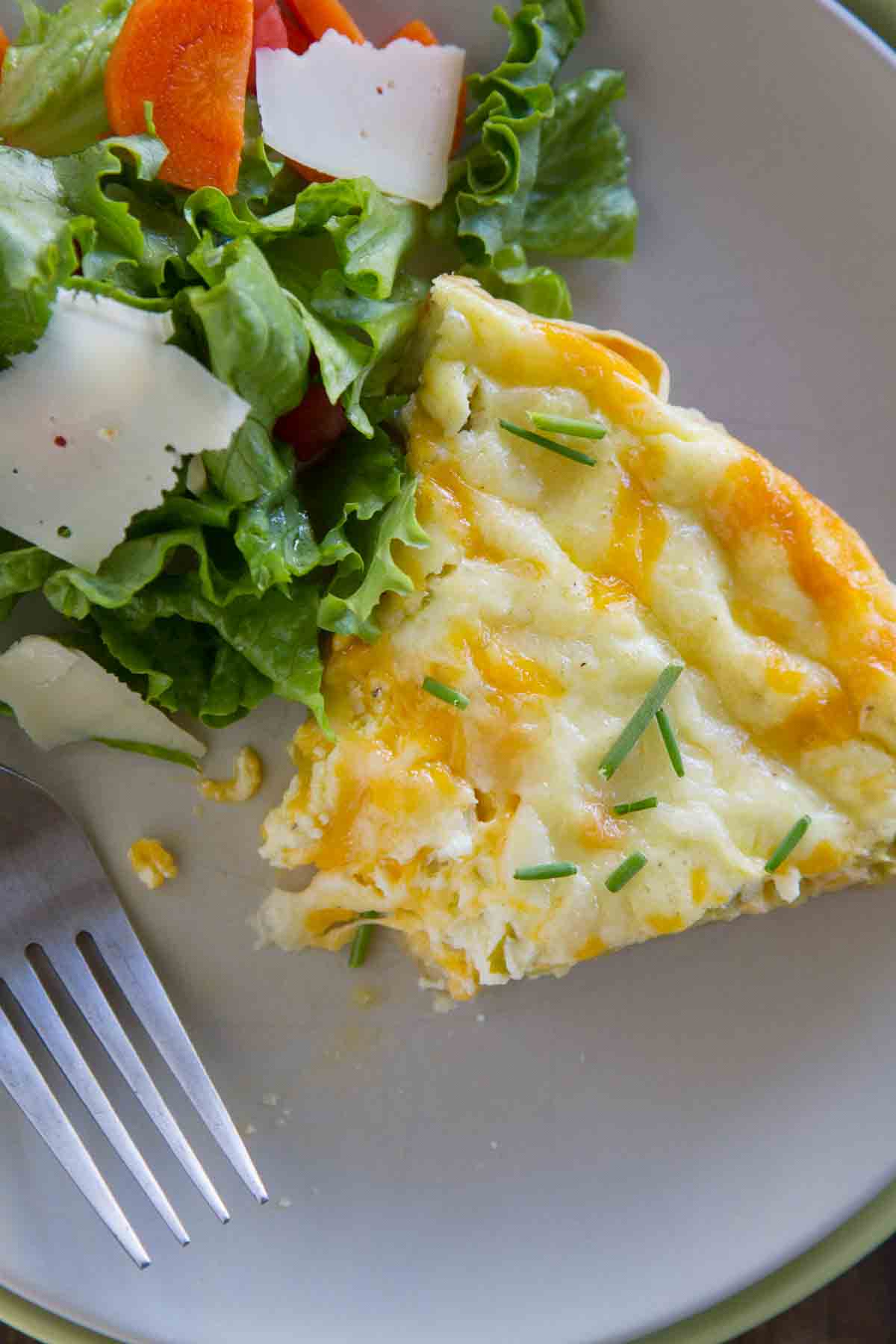 overhead view of slice of green chile tortilla pie with a bite taken from it.