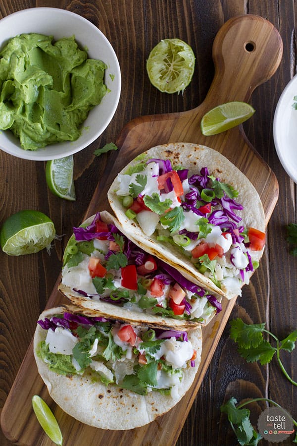 A healthier fish taco, this Baja Fish Taco Recipe has grilled flaky white fish, a creamy avocado sauce, and a tangy white mayo sauce. My idea of a perfect taco night!