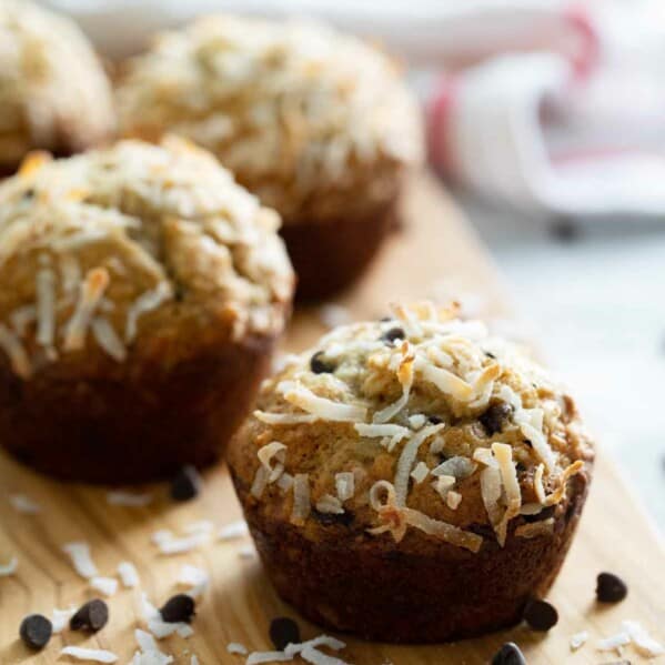 banana chocolate chip muffins on a cutting board with coconut