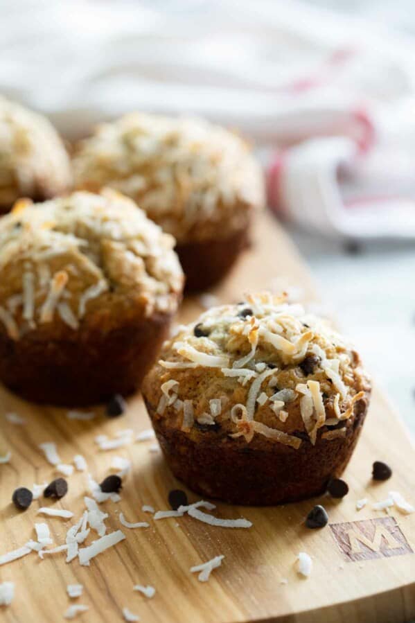 banana chocolate chip muffins on a cutting board with coconut
