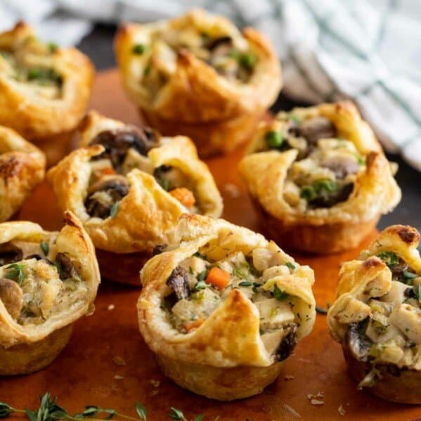 Mini Chicken Pot Pies made with puff pastry on a cutting board.