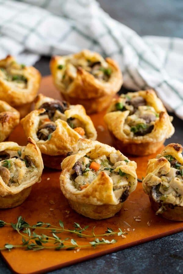 Mini Chicken Pot Pies made with puff pastry on a cutting board.