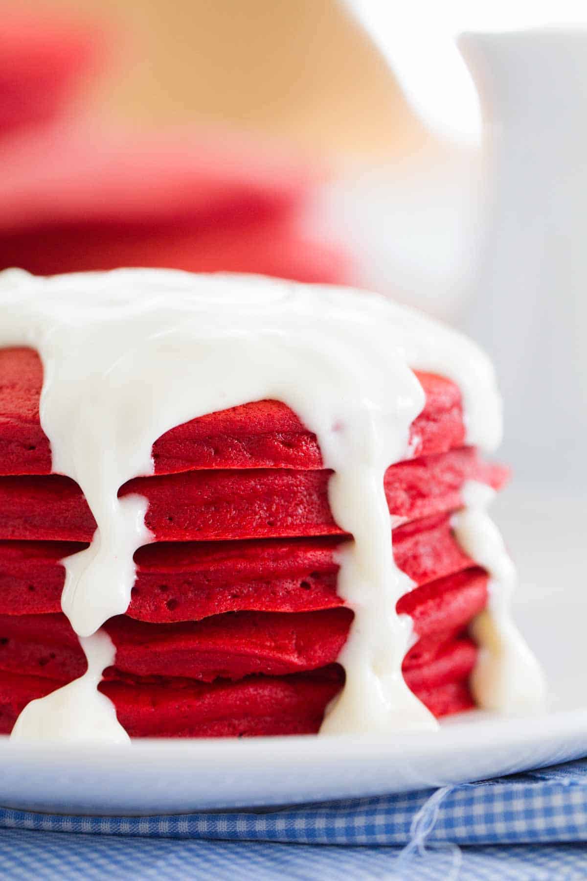 Close up of stack of Red Velvet Pancakes with cream cheese icing.