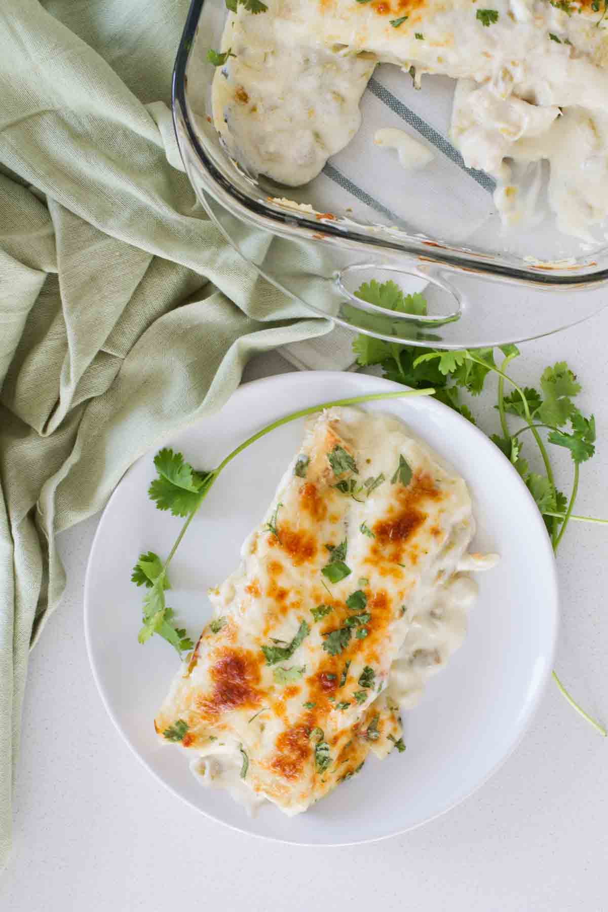 chicken enchiladas on a plate with cilantro