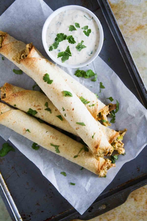 If you are looking for a chicken dinner that will satisfy both kids and adults, these Baked Creamy Chicken Taquitos are your answer! Creamy and flavorful and served with a delicious dressing, everyone loves this dinner idea!