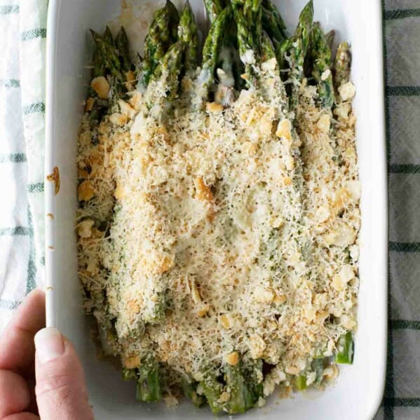 Easy Baked Asparagus in a dish topped with cheese and crackers