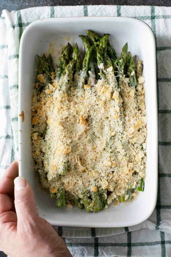 Easy Baked Asparagus in a dish topped with cheese and crackers