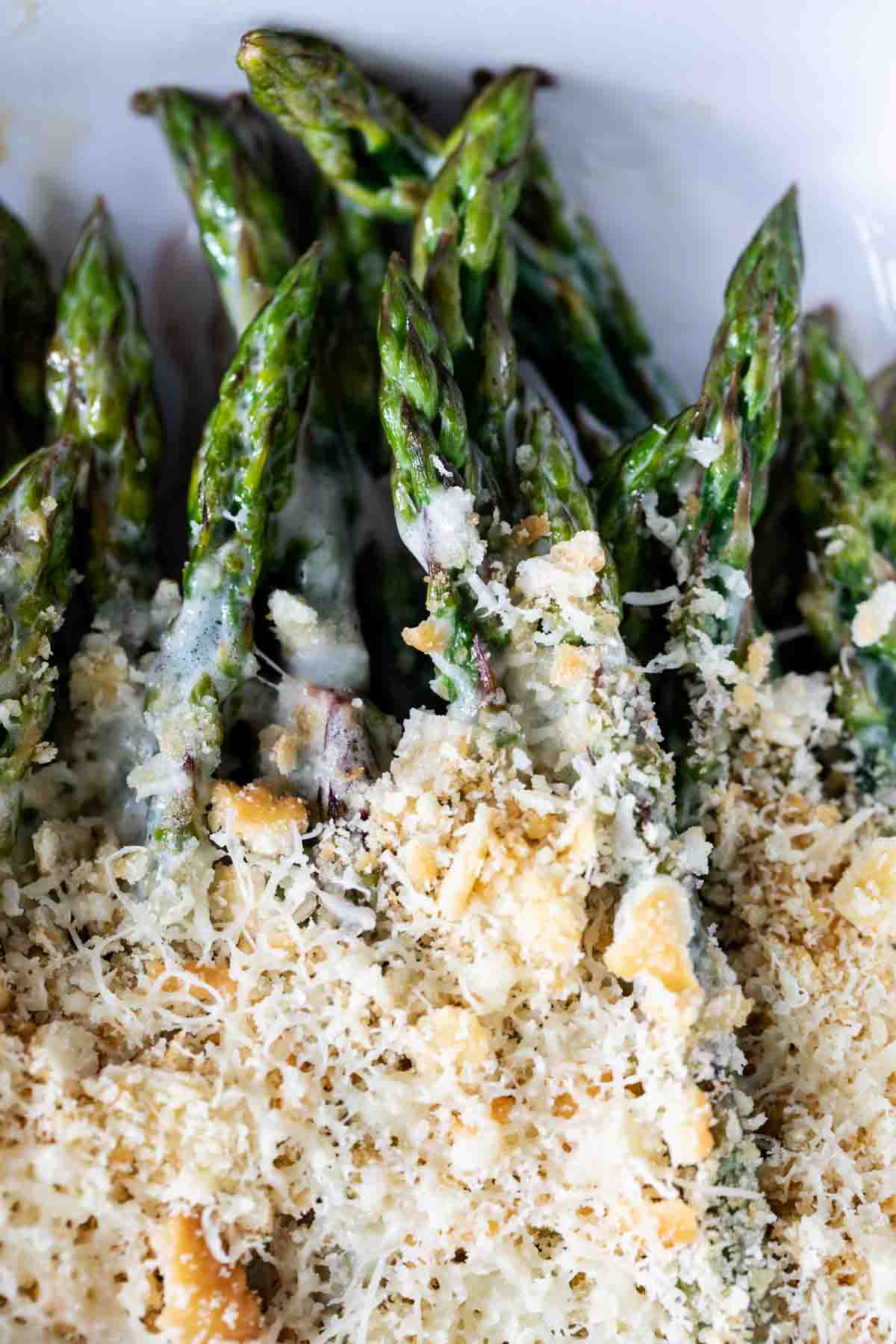 close up of baked asparagus with creamy cheese