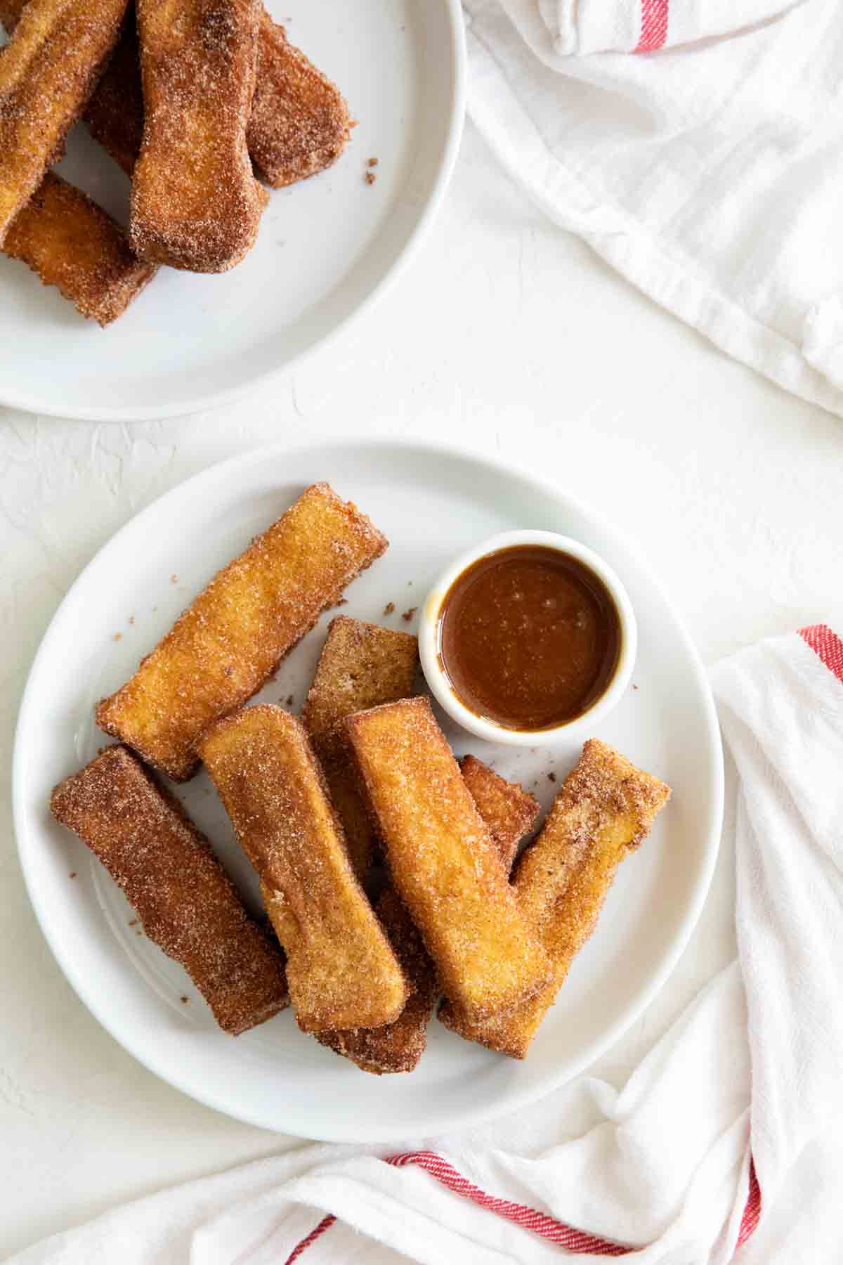 Plates with cinnamon sugar covered French Toast Sticks.