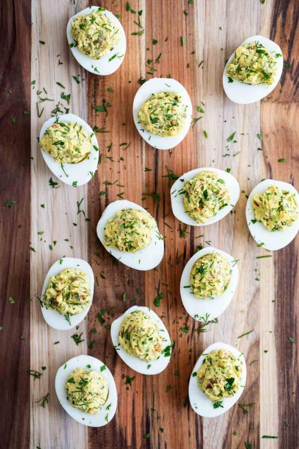 Deviled eggs with green olives and herbs