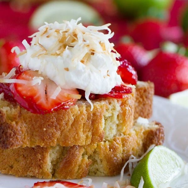 Strawberry Lime Shortcakes with Coconut Cream - Slices of perfect sour cream pound cake are topped with strawberries soaked in a lime syrup and a light coconut cream in this perfect summertime dessert.