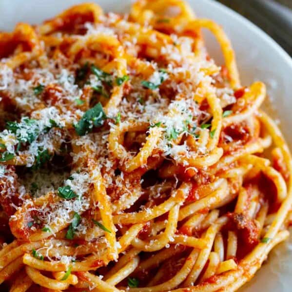 Plate filled with spaghetti with meat sauce.