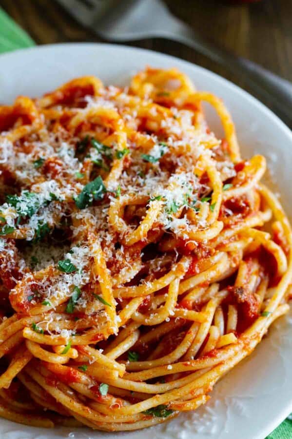 Plate filled with spaghetti with meat sauce.