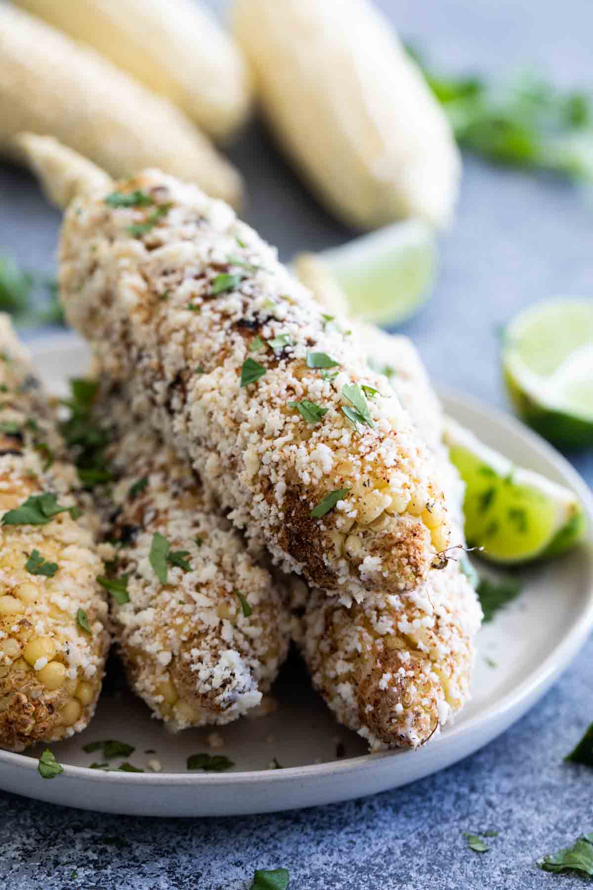 Grilled Mexican Corn on the Cob stacked on a plater