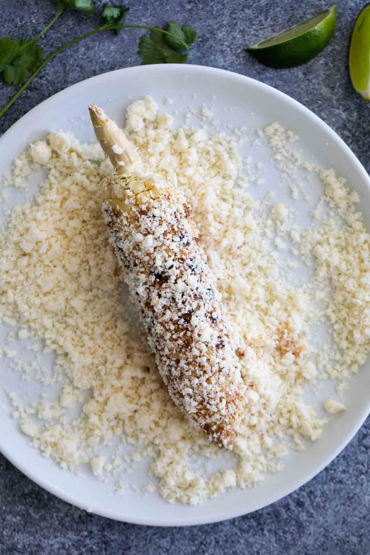 grilled corn covered in cotija cheese