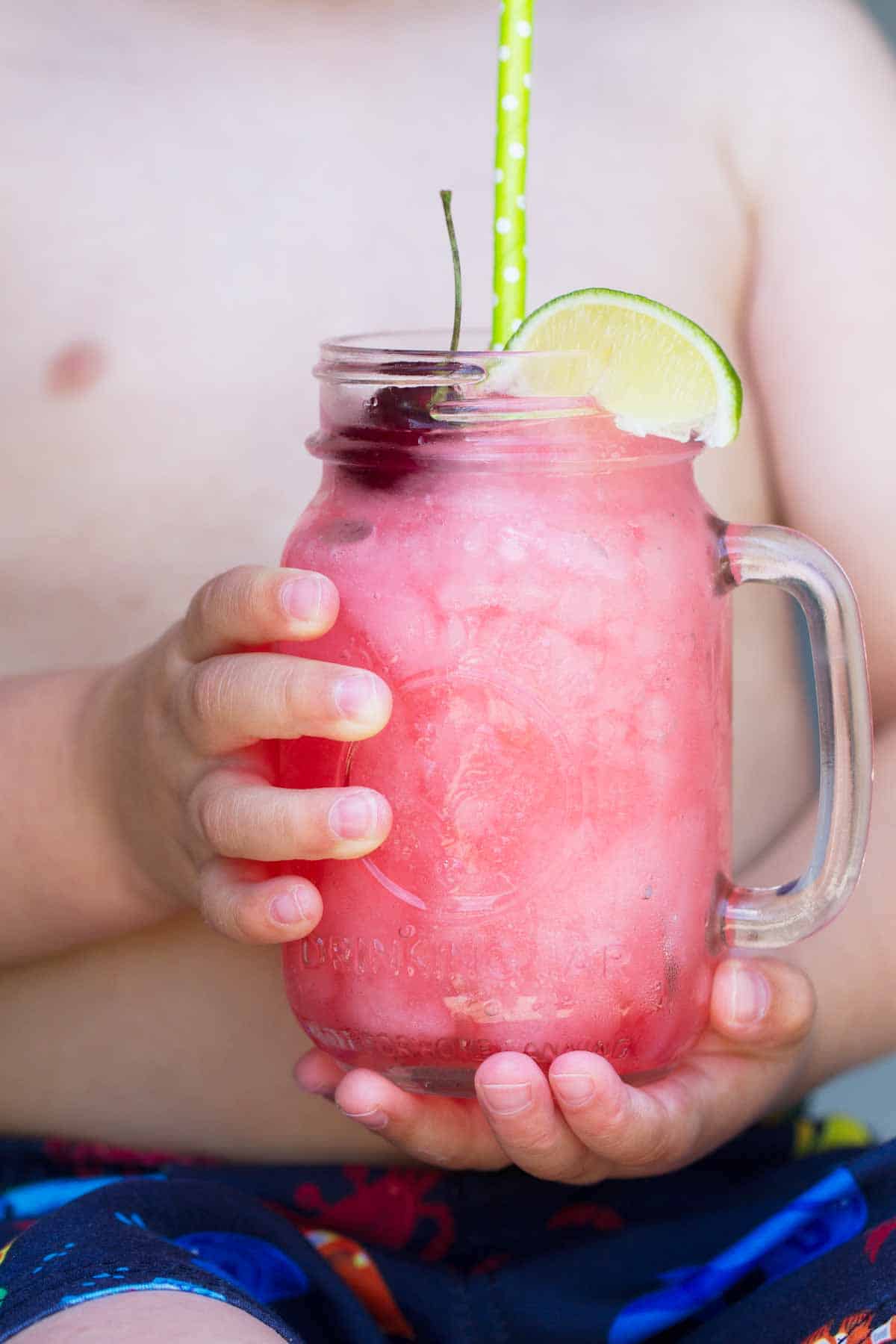 Boy holding a homemade slurp.