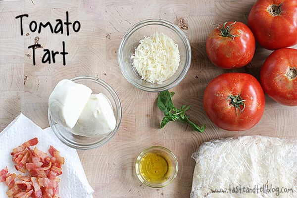 A buttery, flaky crust is filled with fresh tomatoes, bacon and lots of cheese for the perfect end of summer Tomato Tart Recipe.