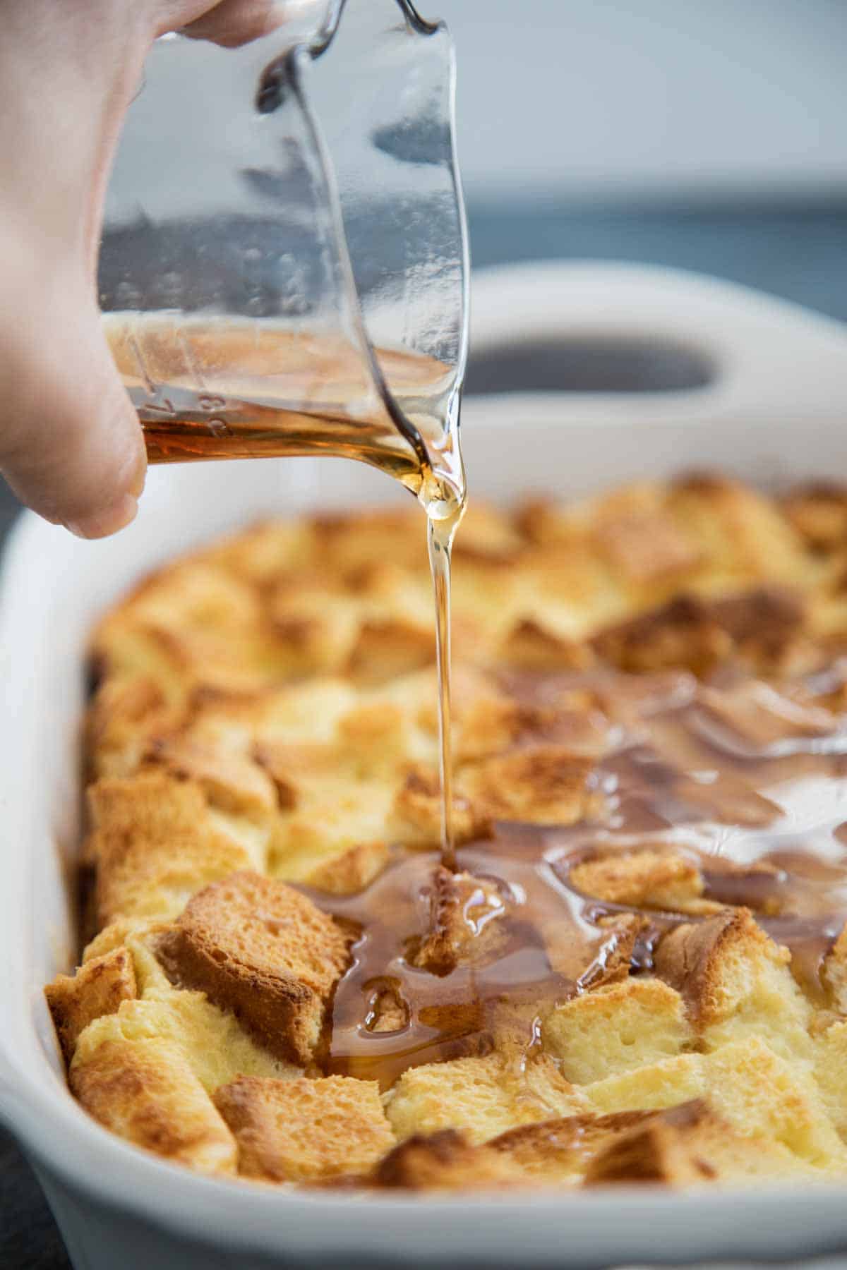 pouring syrup on overnight french toast casserole