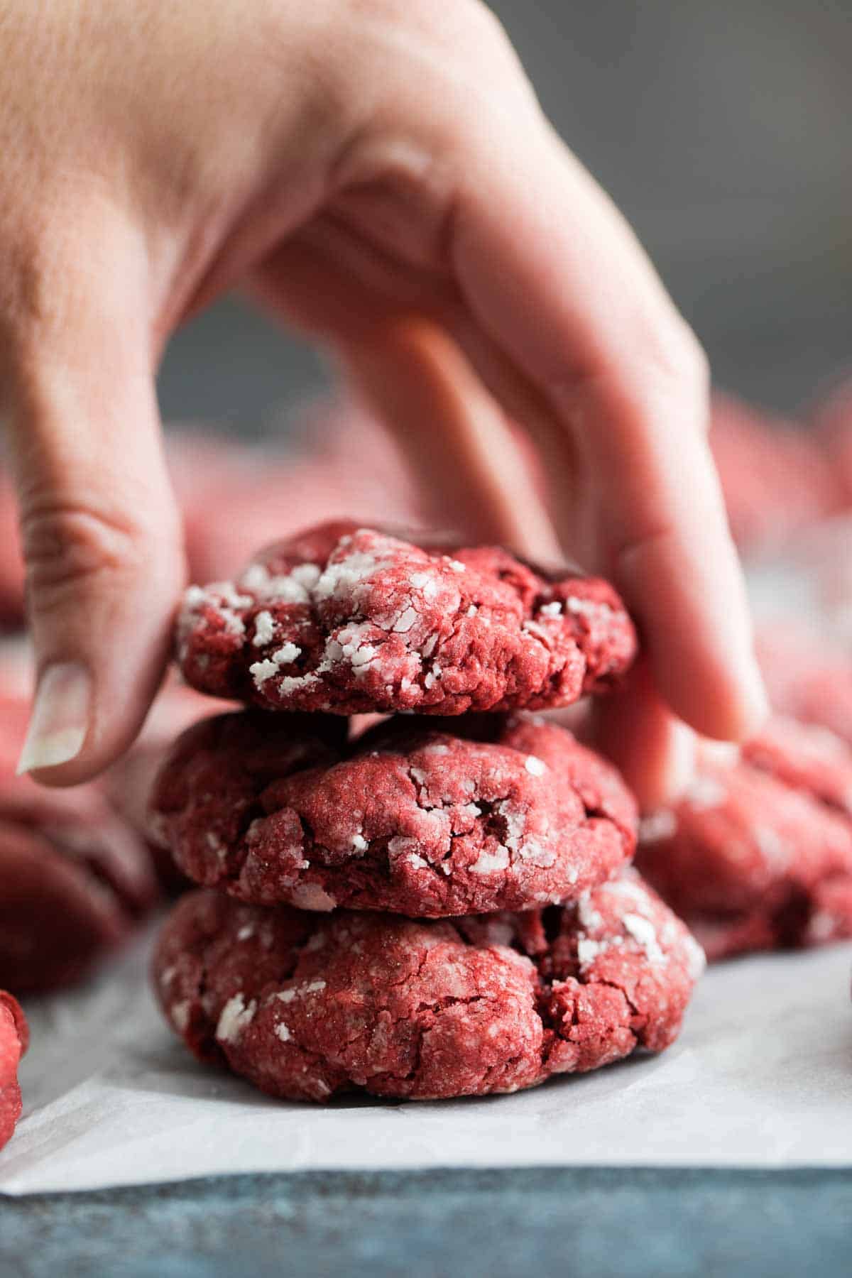 Stacking red velvet gooey butter cookies on top of each other.