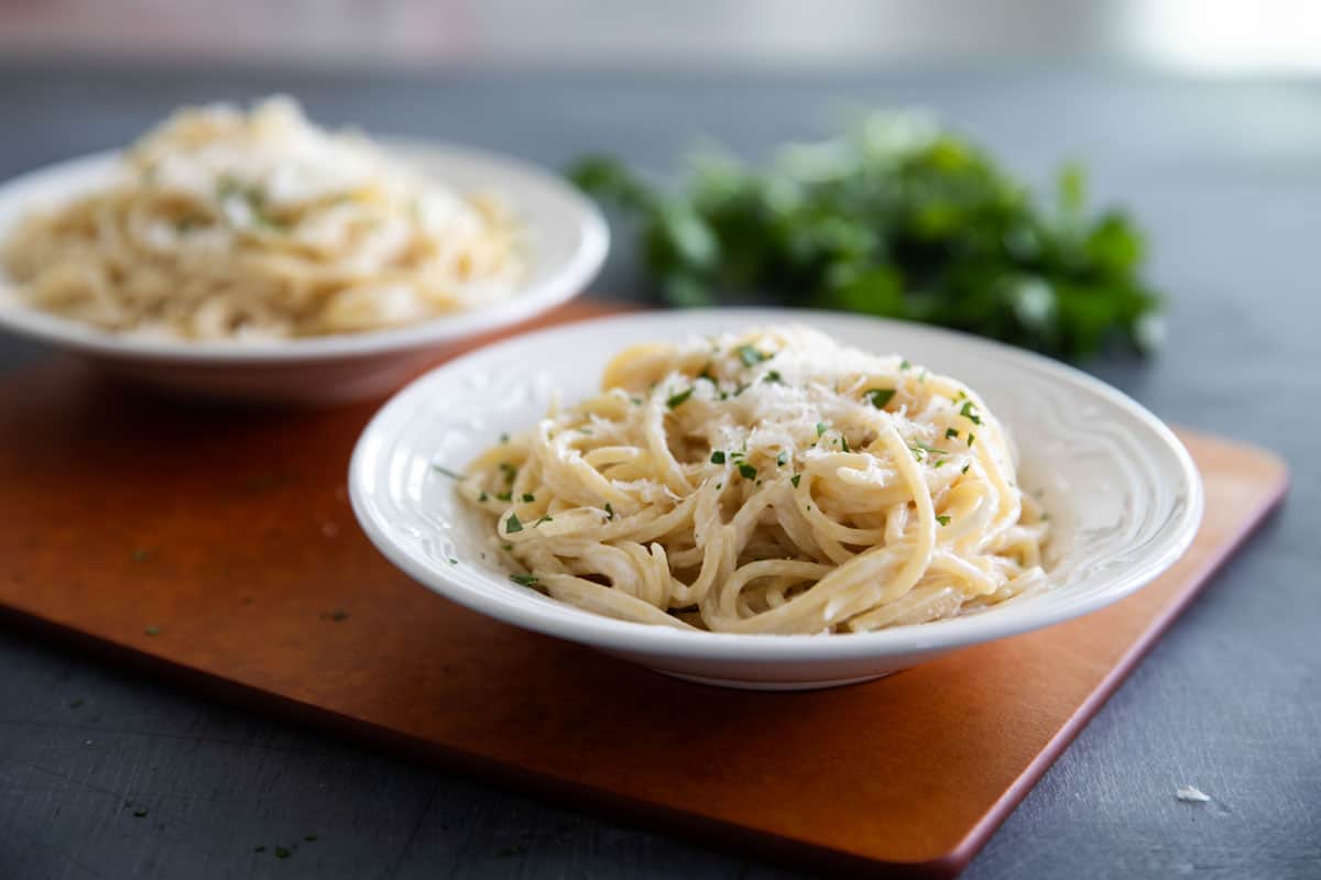 Two bowls filled with parmesan pasta.