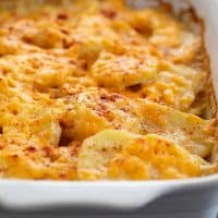 Scalloped Potatoes in a dish, sprinkled with paprika