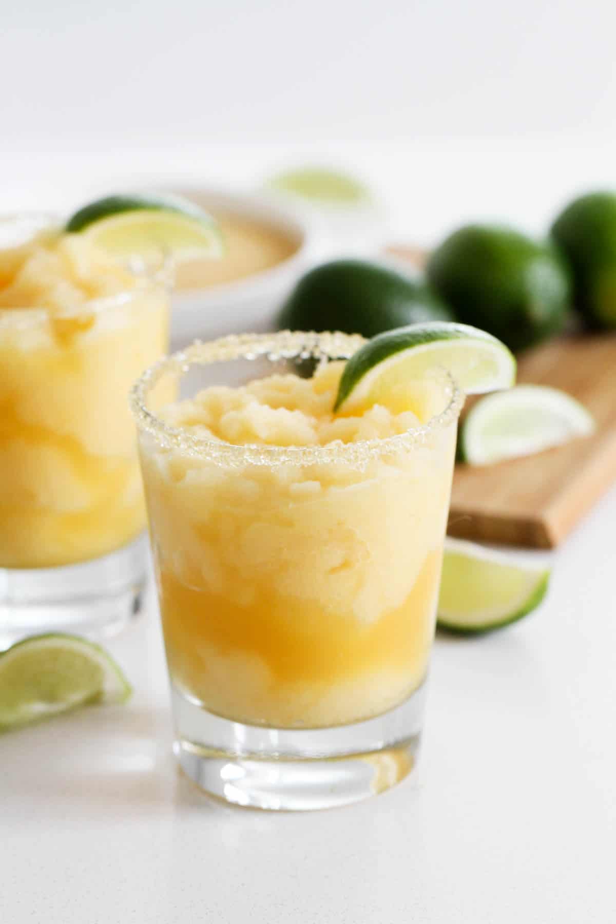 A little bit tart, a little bit sour, and a little bit sweet, these Virgin Frozen Margaritas come together in just minutes and are super family friendly! Virgin Frozen Margaritas with lime slices
