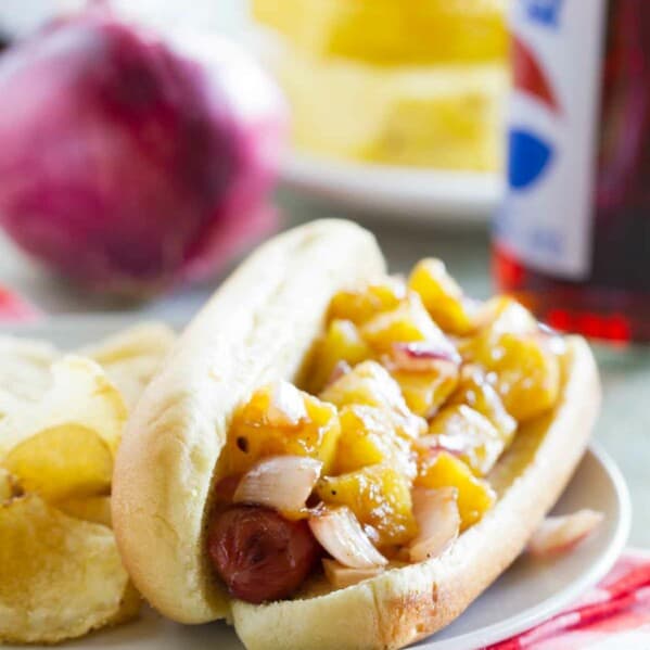 Hawaiian Hot Dog on a plate with chips
