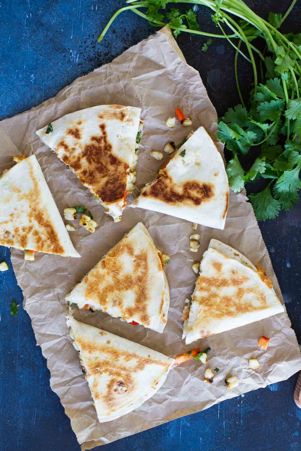 Grilled corn quesadilla triangles on brown parchment