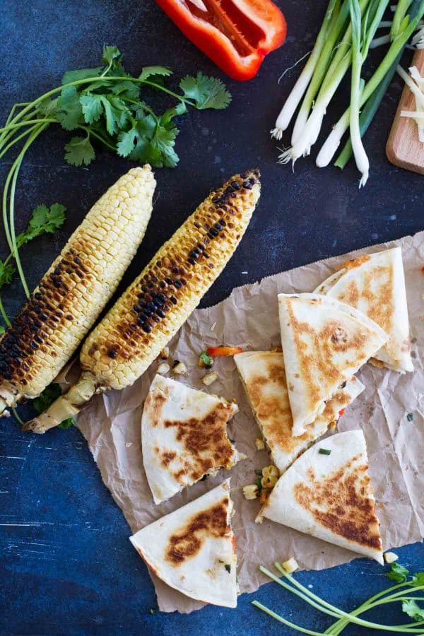 This Grilled Corn Quesadilla Recipe is a delicious vegetarian dinner. Tortillas filled with grilled corn and veggies pair up with melty cheese in this delicious summer meal. Easy summer dinner - Grilled Corn Quesadilla Recipe