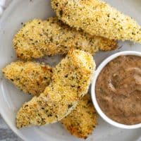 Crispy Ranch Chicken Strips on a plate with ranch bbq dipping sauce.