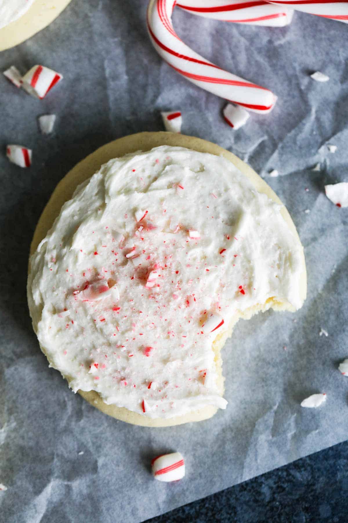 Easy Soft Sugar Cookie Recipe with peppermint flavor and crushed candy canes on top.