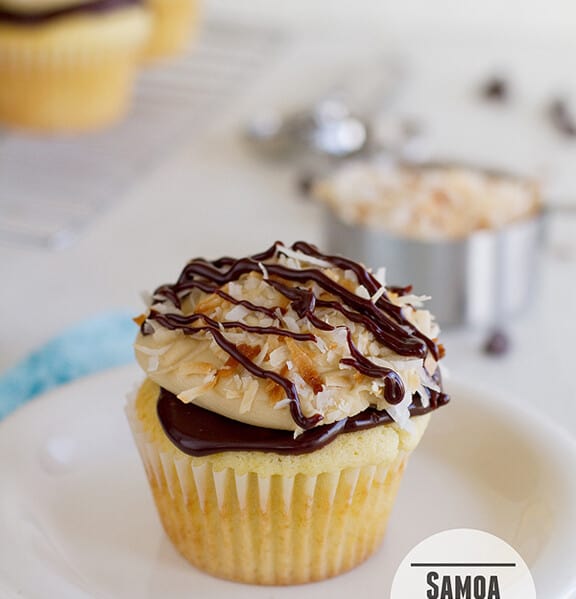 Samoa Cupcake - a yellow cupcake filled with caramel and topped with chocolate ganache, caramel buttercream and toasted coconut | www.tasteandtellblog.com