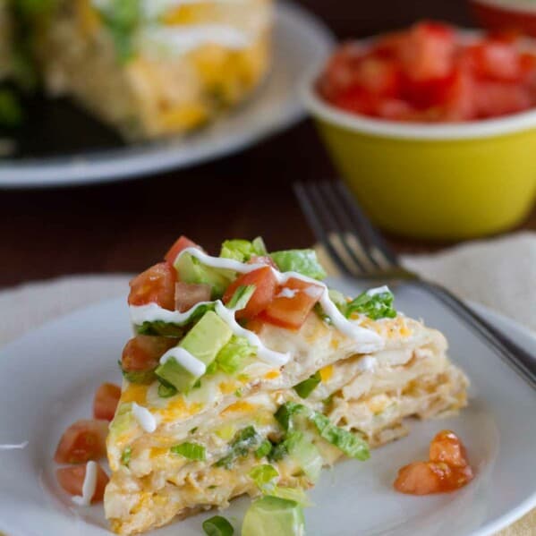 slice of chicken tortilla stack topped with tomatoes and avocado
