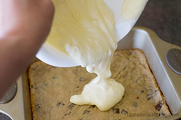 Pouring cheesecake batter over cookie base.