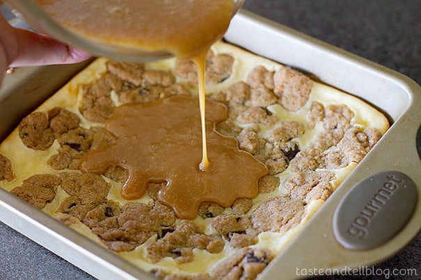 Adding caramel on Caramel Cookie Cheesecake Bars.
