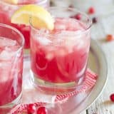 glasses of sparkling cranberry punch with lemon slices on the glass
