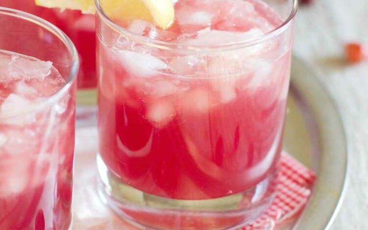 glasses of sparkling cranberry punch with lemon slices on the glass