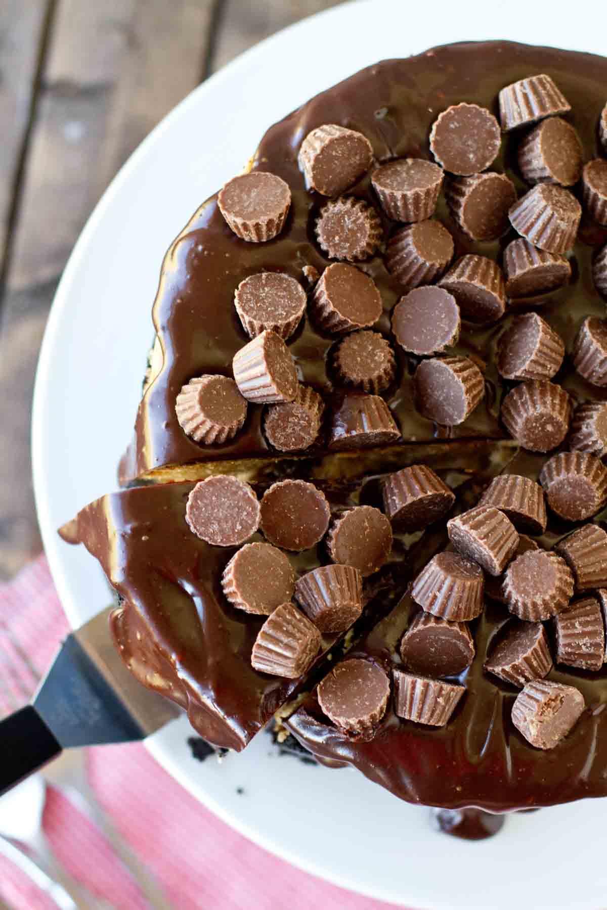 top of cheesecake with chocolate ganache and mini Reese's peanut butter cups.