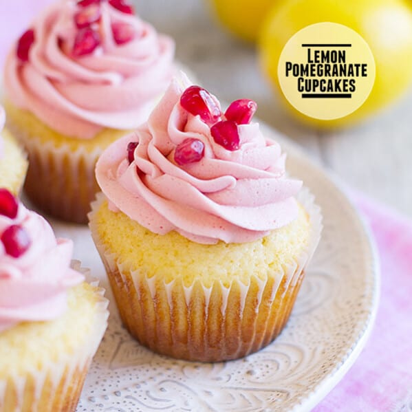 Lemon cupcakes are topped with a light pomegranate frosting and fresh pomegranate seeds in these light and refreshing Lemon Pomegranate Cupcakes.