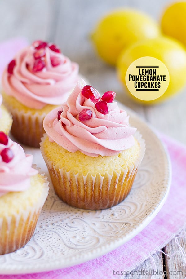 Lemon cupcakes are topped with a light pomegranate frosting and fresh pomegranate seeds in these light and refreshing Lemon Pomegranate Cupcakes.