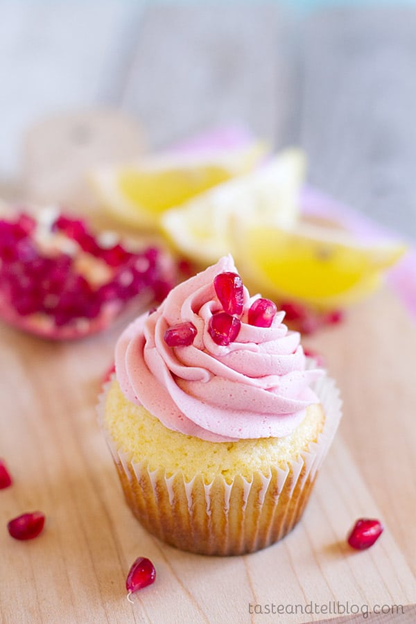 Lemon cupcakes are topped with a light pomegranate frosting and fresh pomegranate seeds in these light and refreshing Lemon Pomegranate Cupcakes.