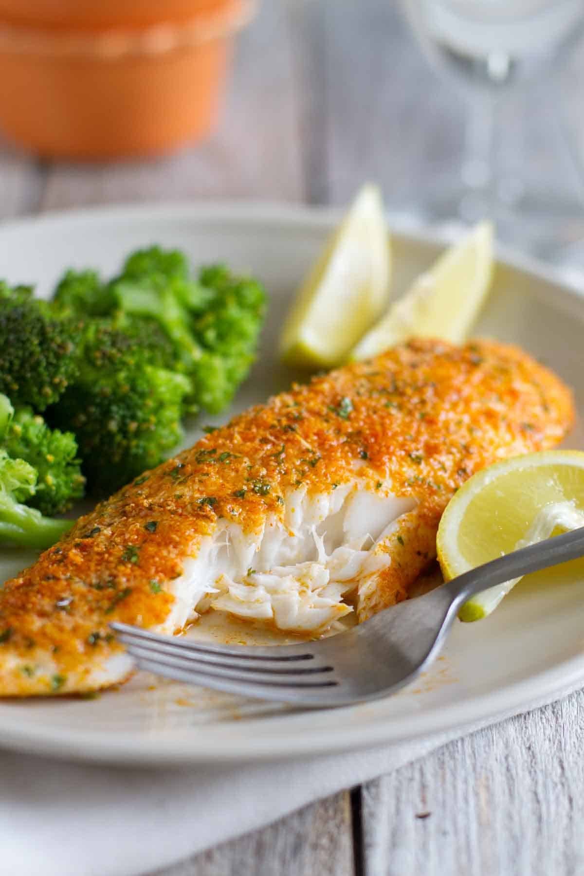 This Parmesan Crusted Tilapia is a simple fish recipe that is done in 20 minutes and will even impress non-fish lovers! texture of cooked Parmesan Crusted Tilapia