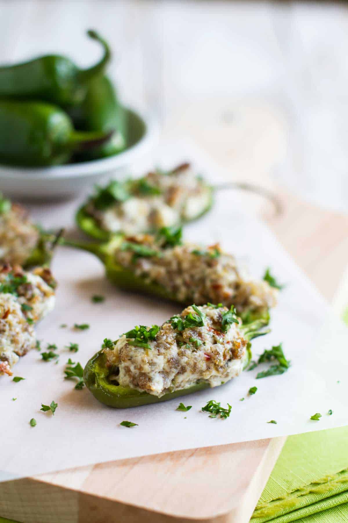 Stuffed Jalapenos with Sausage and Cream Cheese on parchment paper