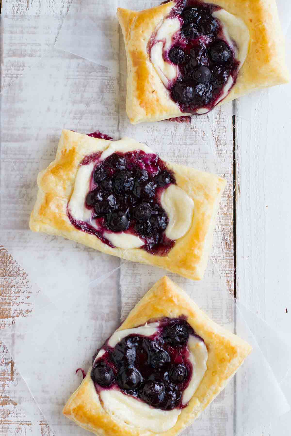 Top view showing puff pastry danish with cream cheese and blueberries on top.