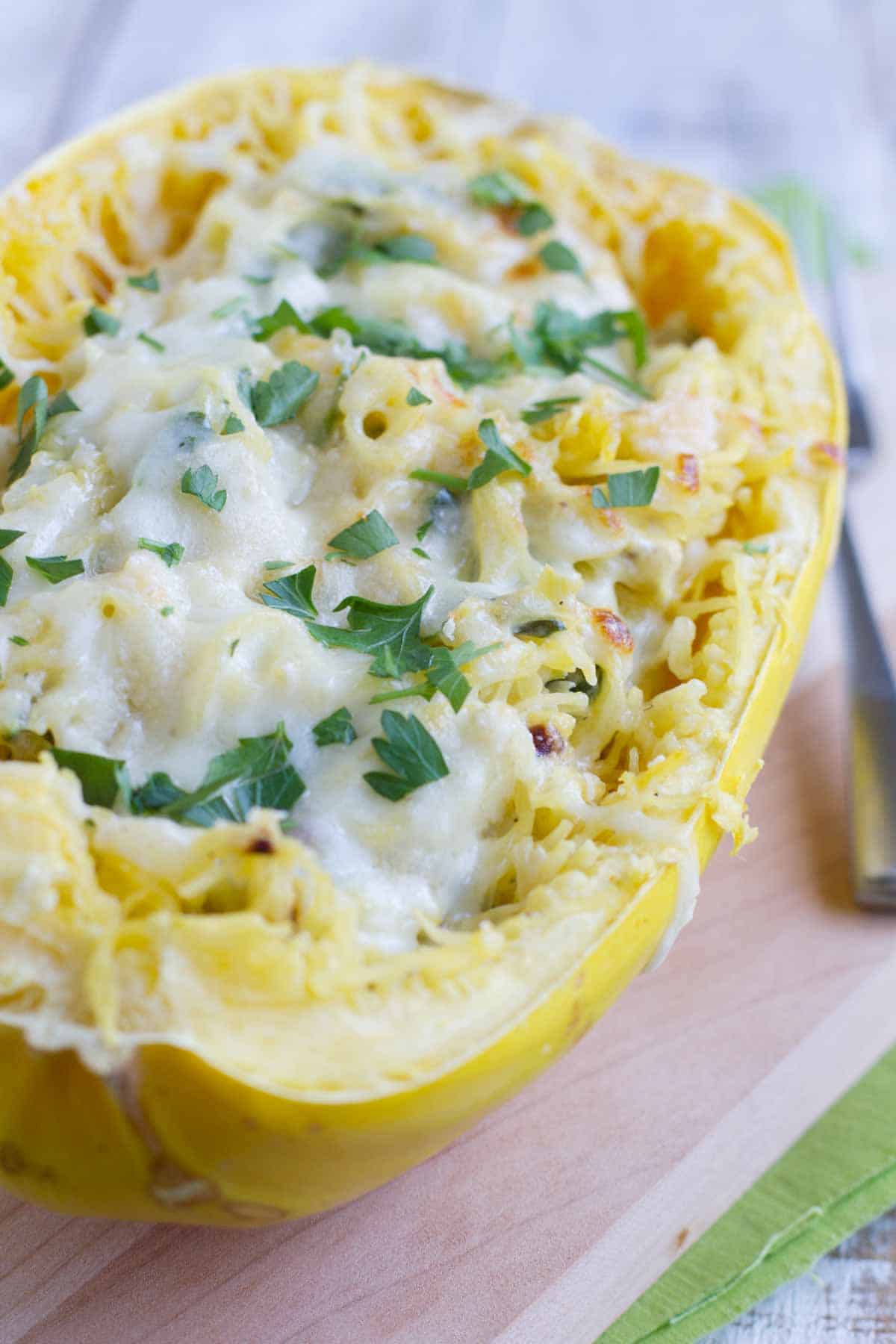 Spinach Artichoke Spaghetti Squash topped with cheese.