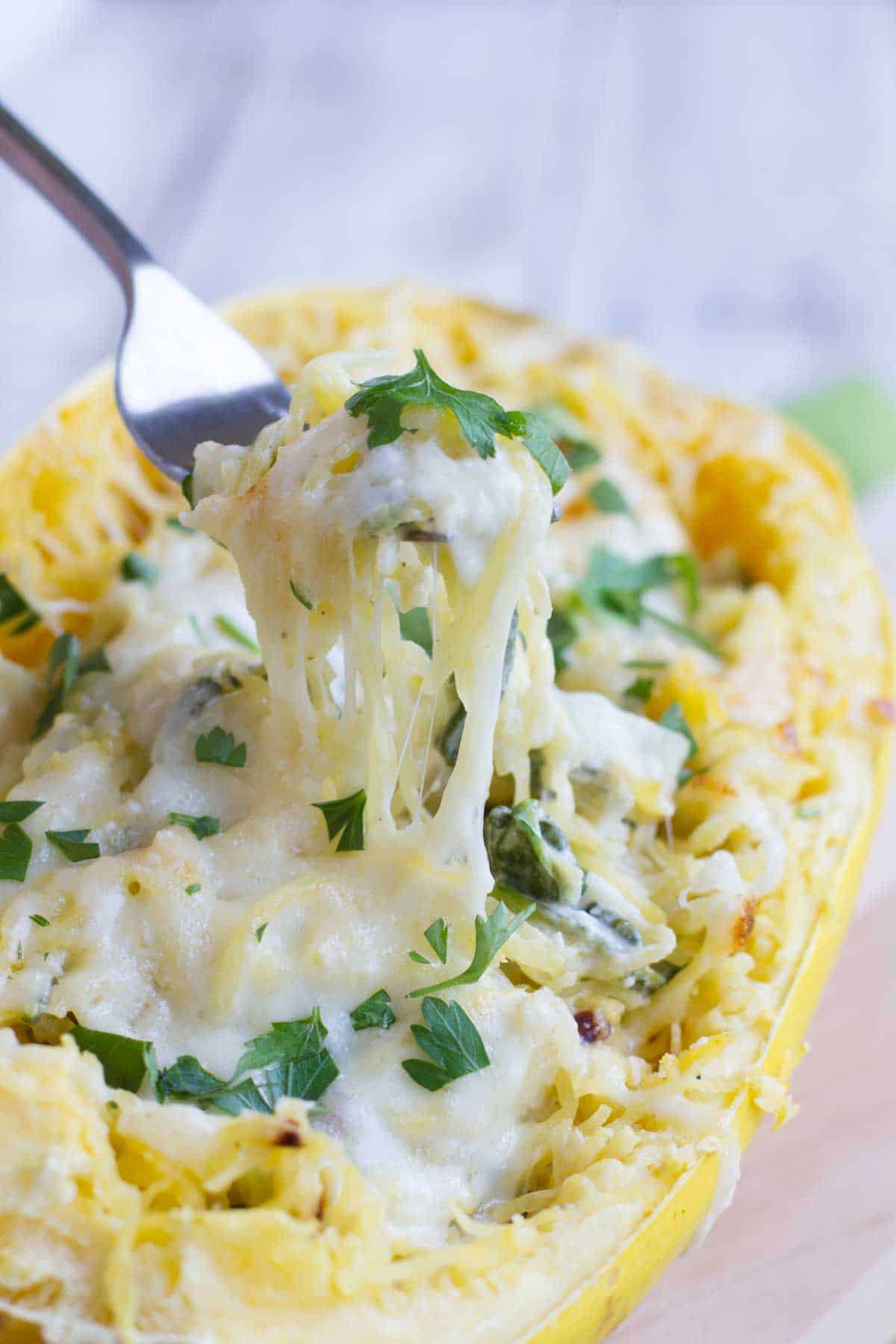 Fork in Spinach Artichoke Spaghetti Squash.