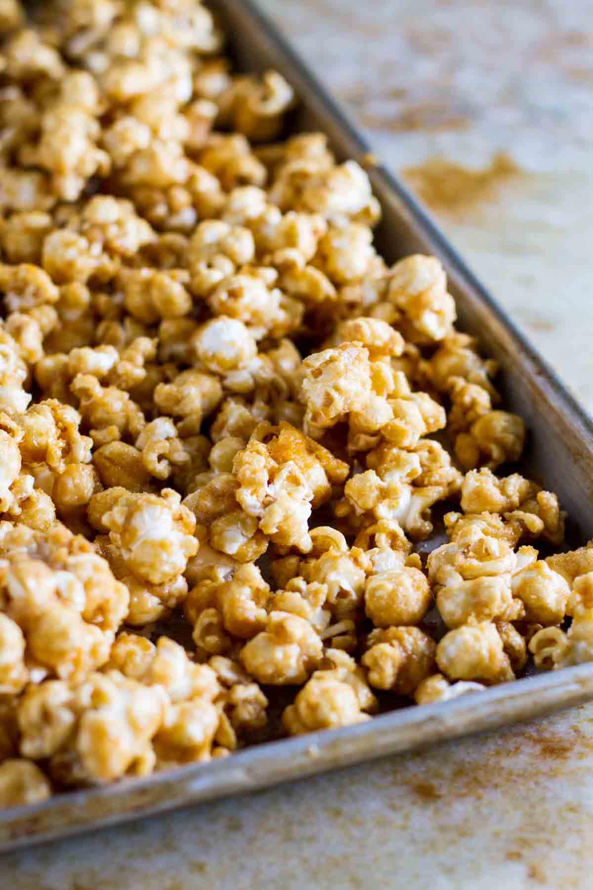 Baked caramel popcorn on a baking sheet.